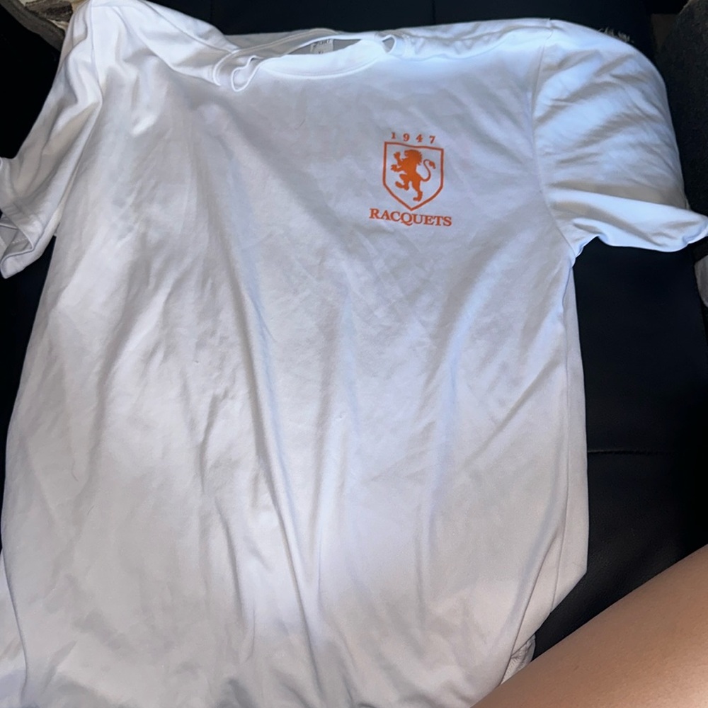 A xl white shirt with a 1947 racquets logo